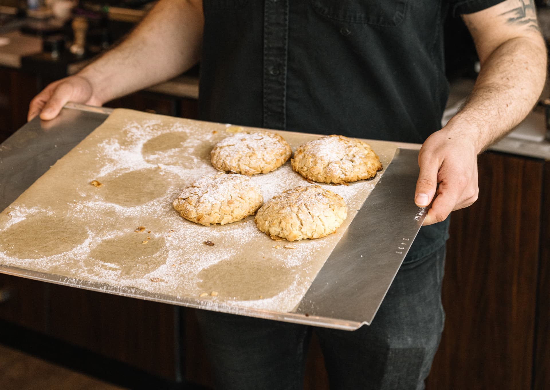 Erik carrying a tray of freshly baked cookies
